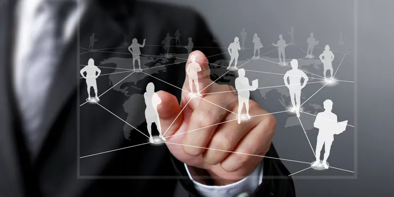 Person pointing at overlay graphics of people on positions around a map